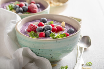 Sweet cream cold soup with frozen berries and mint.