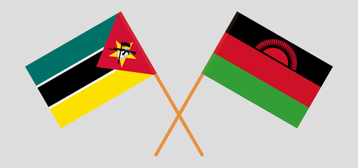Crossed flags of Mozambique and Malawi. Official colors. Correct proportion