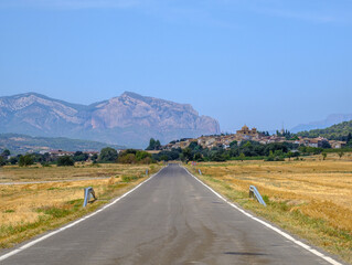 mallos Riglos Huesca Spain country road empty damaged asphalt in the countryside long straight way
