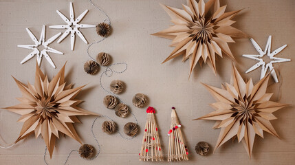 DIY decorations, paper bag stars, snowflakes with clothespins, Christmas tree with barbeque sticks and garland with honeycomb paper balls. Ecological and sustainable celebration. Top view, banner