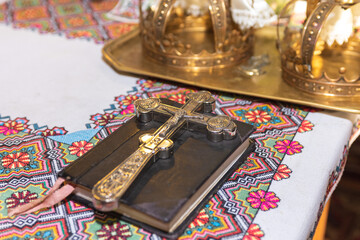 Two beautiful wedding crowns and wedding rings on a pillow in the church. The concept of marriage in the church, starting a family 