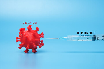 A picture of 3D printed coronavirus with omicron variant word, vaccine and booster shot word....