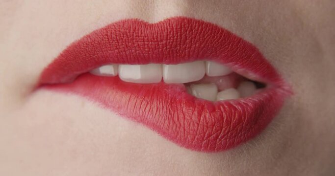 Teeth Bitting Red Lips a Macro Shot of Female Mouth
