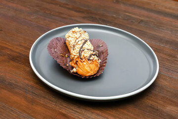 fresh baked sweet creamy eclair sweet dessert on plate kitchen wooden table, sugar food, utensils...