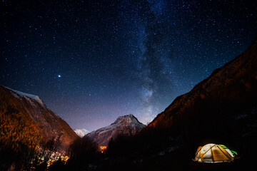 Pitched tent under the milky way during a hike of the tour du mont blanc