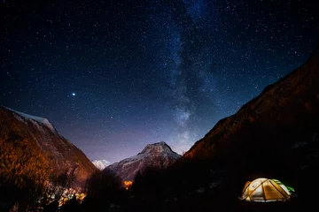 Wall murals Mont Blanc Pitched tent under the milky way during a hike of the tour du mont blanc