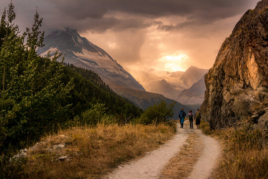 Three hikers in front of Matterhorn mountain in Zermatt, Switzerland
