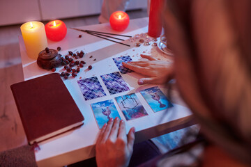 Mysterious soothsayer doing a Tarot card reading