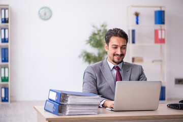 Young male employee working in the office