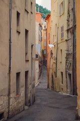 Fototapeta na wymiar Narrow street with colorful houses in Antibes - Antibes, Côte d'Azur, French Riviera, France