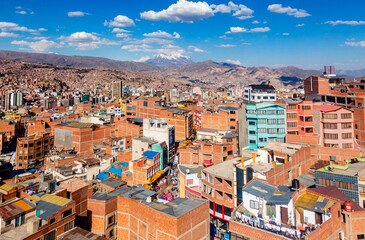 Colorful streets of La Paz with snow cap of Illimani peak, La Paz city, Bolivia