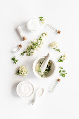 Set of white medical herbal cosmetics for skin care and beauty treatment with flowers