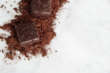 Dark Chocolate Petit Four Cakes on Cocoa and SprinklesFlat Lay, VAlentine's Day Dessert