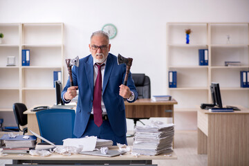 Old male employee unhappy with excessive work in the office
