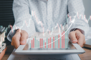 Business woman touching holographic graphs and stock market statistics gain profits from the screen of digital tablet computer, Business growth, progress or success concept.