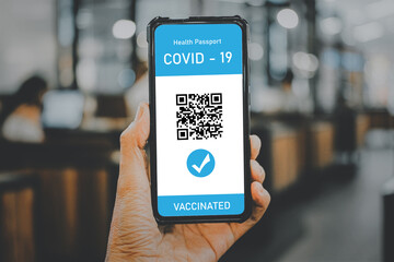Man hand using digital health passport app in mobile phone for travel during covid-19 pandemic, Vaccination passport for covid-19, health and surveillance concepts.