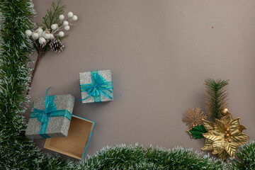 Fototapeta na wymiar Christmas background with a green garland frame and two gifts on a blue background