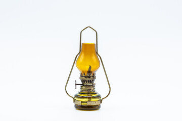 Small oil lantern on white background, Camping light and interior decoration, vintage brass case.