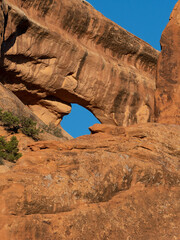 A Small Window in Sandstone near Landscape Arch in Arches National Park in Utah