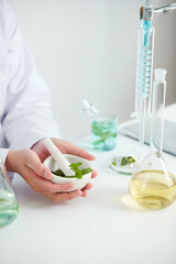 Naklejka premium Plants and flowers extract in petri dish and a white background in laboratory , green leaf in a test tube and doctor for cosmetic advertising , photography science concept