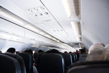 Passenger Airplane Room.Interior of airplane with passengers on seats.