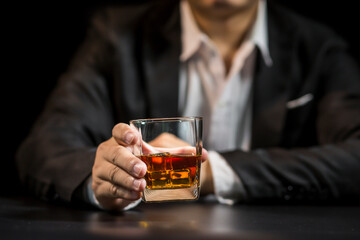 Closeup businessmen holding a glass of whiskey