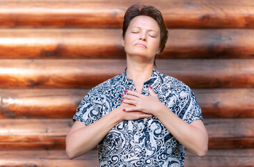An adult woman practicing Qigong breathing exercises