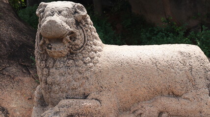 Tharamaraja Stone Throne This is a large rectangular lion-shaped throne carved out of a single stone. one side view Incomplete stone sculpture with blur backround