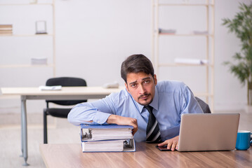 Young male employee working in the office