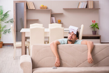 Young man student wearing virtual glasses at home