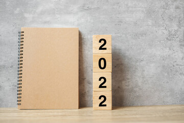 2022 Happy New Year with blank notebook and wooden number. countdown, Resolution, Goals, Plan,...