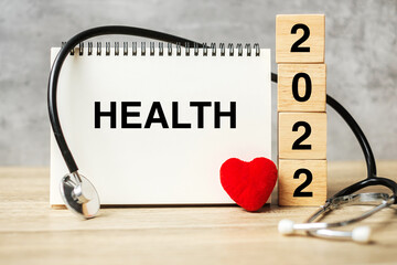 2022 Happy New Year for healthcare, Insurance, Wellness and medical concept. Stethoscope of doctor on table