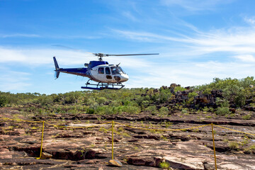 Helicopter lands in outback Australia.