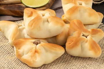 A pile of delicious meat sfiha.