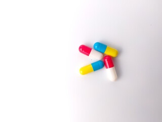 Top view piles of pills and capsule on white background,isolated,copy space.Selective focus.