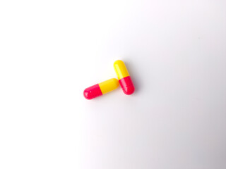 Top view piles of pills and capsule on white background,isolated.Selective focus.