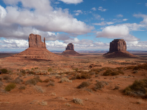 Monument Valley's West Mitten, East Mitten, and Merrick Buttes Under Cloudy Skies