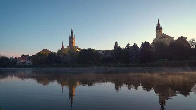 czech city Caslav seen over a steaming pond in the morning, static