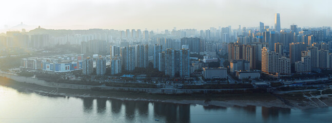 The city is in Chongqing, China. The river is called the Jialing River. At sunset, the city has warm sunlight afterglow