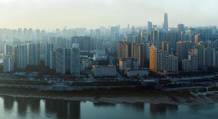 The city is in Chongqing, China. The river is called the Jialing River. At sunset, the city has...