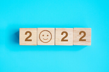 Smile face block with 2022 text on blue background. Satisfaction, feedback, Review and New Year...