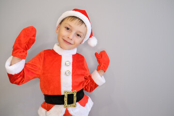 a little boy in a santa costume