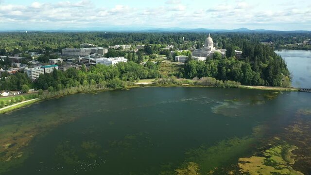 Cinematic 4K aerial drone dolly in clip of the Washington State Capitol Building and Campus, Capitol Lake and a panoramic view of Historic District in Olympia, Washington