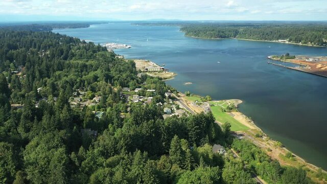 Cinematic 4K aerial drone footage of West Bay, Crestline, Westside Olympia with a panoramic view of the Entrance Channel, harbor, port and downtown in Olympia, Washington