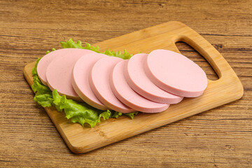 Sliced sausage snak over board