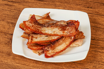 Roasted juicy bacon in the plate