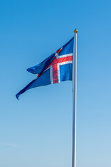 View of the beautiful Iceland Flag waving its beautiful Red, white and blue colors in the Thingvellir National Park 