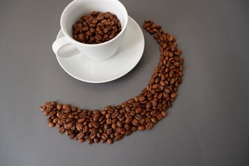 Coffee beans and cup & saucer on gray background. Cafe, Coffee, restaurant design elements.