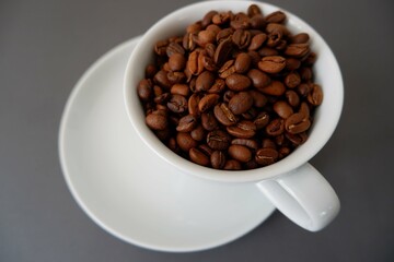 Coffee beans and cup & saucer on gray background. Cafe, Coffee, restaurant design elements.