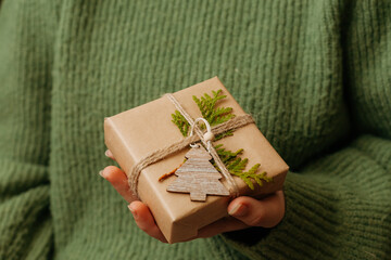 Cozy Christmas present in woman's hand, close up